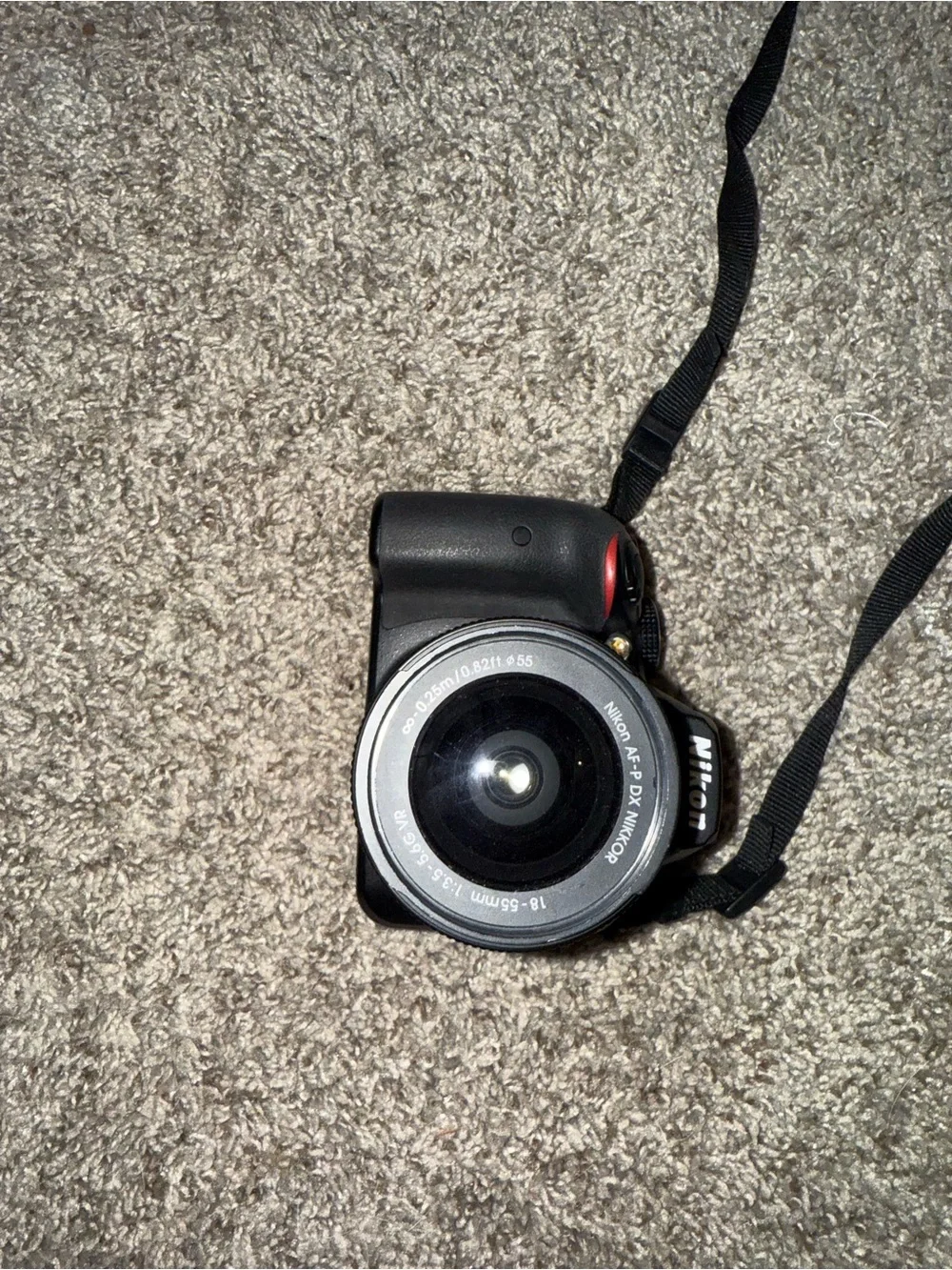 Nikon Black DSLR with Zoom Lens and Branded Neck Strap